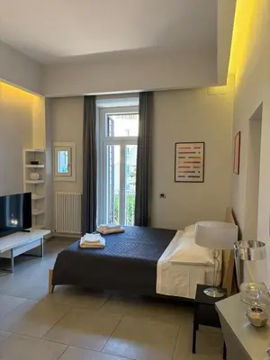 a bedroom with a bed and a large window at Casa Gabri in Rome