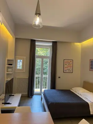 a bedroom with a bed and a desk and a window at Casa Gabri in Rome