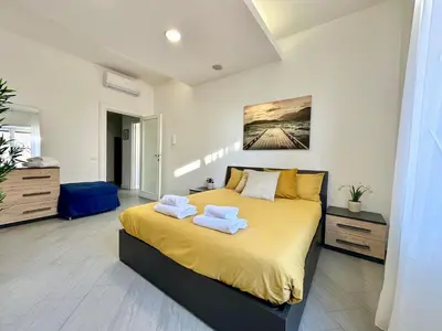 a bedroom with a large bed with towels on it at Sergio I Apartment in Rome