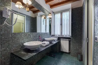 a bathroom with two sinks and a mirror at Antico Platano in Rome