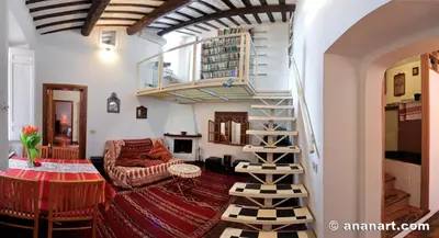 a living room with a spiral staircase in a house at Nido tra le cupole, terrazza panoramica, Wi-Fi , AC in Rome