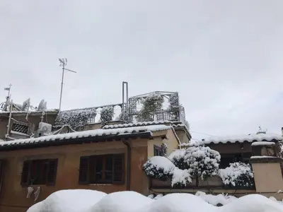 a house with snow on the roof at Nido tra le cupole, terrazza panoramica, Wi-Fi , AC in Rome