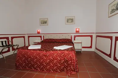 a bedroom with a bed with a red bedspread at Startermini in Rome