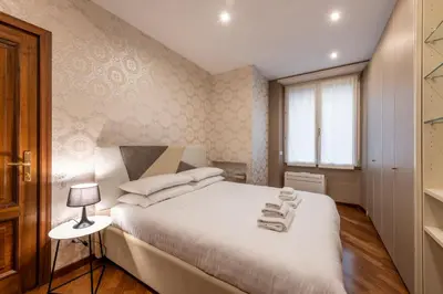a bedroom with a white bed with towels on it at ROMA 1 - Elegante Appartamento con Terrazzo in Rome
