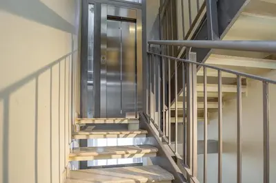 a staircase in a building with a glass door at Chic Spanish Steps Retreat in Rome