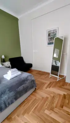 a bedroom with a bed and a wooden floor at Little Diamond in Gianicolense in Rome