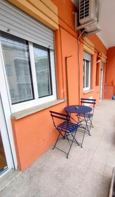 two chairs and a table in front of a building at Little Diamond in Gianicolense in Rome
