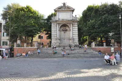 a group of people sitting on steps in front of a monument at Fissa Dimora in Rome