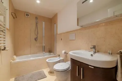 a bathroom with a sink and a toilet and a tub at Luxury 3 beds 3 baths, few steps from city center in Rome