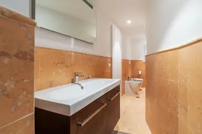 a bathroom with a sink and a toilet at Luxury 3 beds 3 baths, few steps from city center in Rome