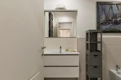 a bathroom with a sink and a mirror at The Mirror Suite next to Spanish Steps in Rome
