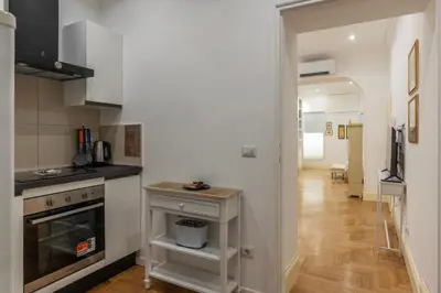 a kitchen with a sink and a stove top oven at The Mirror Suite next to Spanish Steps in Rome