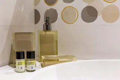 a bathroom sink with two bottles of cosmetics on it at Iflat Cozy Flat at two steps from Vatican in Rome