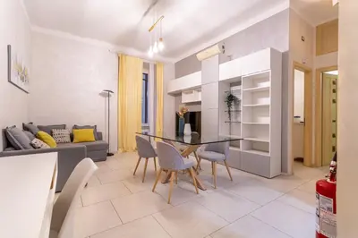 a kitchen and living room with a table and chairs at Iflat Cozy Flat at two steps from Vatican in Rome