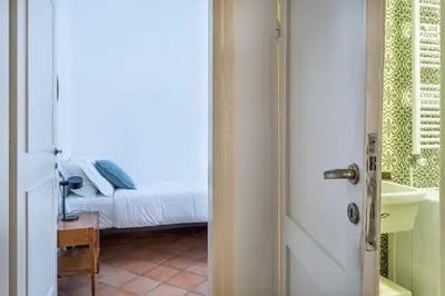 a door leading to a bedroom with a bed at Iflat Comfortable & Spacious Dolce Vita Retreat in Rome