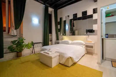 a bedroom with a bed and a large mirror at Luxury Trevi in Rome