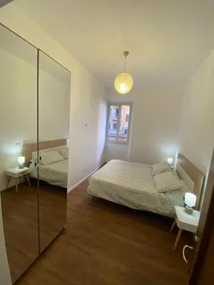 a bedroom with two beds and a mirror at Domus Porta Furba in Rome
