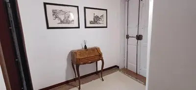 a room with a chair and two pictures on the wall at Casetta clodio in Rome