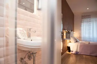 a bathroom with a sink and a bed in a room at Domus Casaletto in Rome