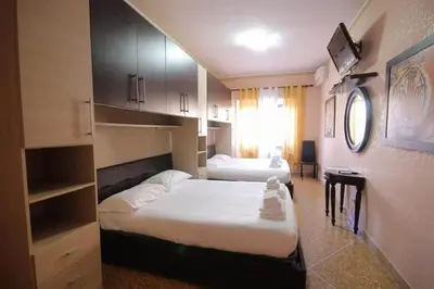 a hotel room with two beds and a window at Er Pirata in Rome