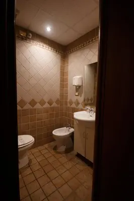 a bathroom with a toilet and a sink at Er Pirata in Rome