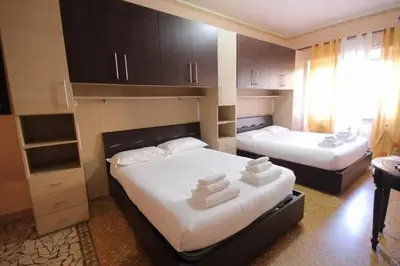 a bedroom with two beds with towels on them at Er Pirata in Rome