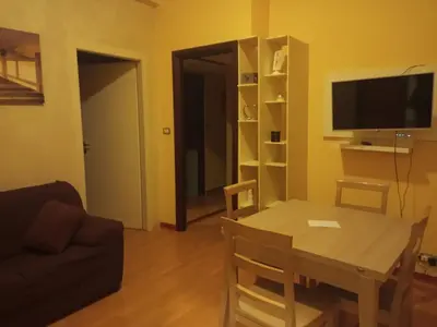 a living room with a table and a television at Casa Gemelli Gemelli in Rome
