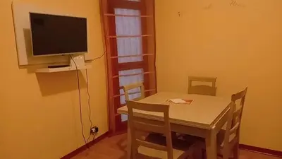 a small dining room with a table and a television at Casa Gemelli Gemelli in Rome