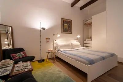 a bedroom with a bed and a living room at The Luxury Roma Amor in Rome