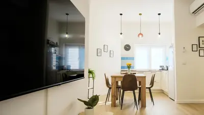 a kitchen and dining room with a table and chairs at Elegantis Santa Croce Suite Apartment in Rome