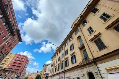 a city street with tall buildings and a blue sky at Balconcino romantico a via Aosta in Rome