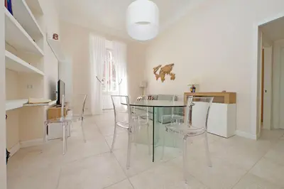 a dining room with a glass table and chairs at Balconcino romantico a via Aosta in Rome