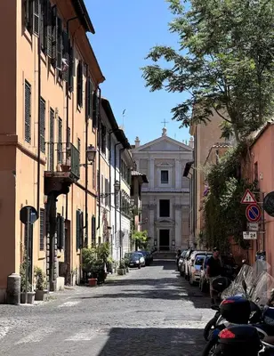an empty street with a building in the background at Children House Apartment in Rome