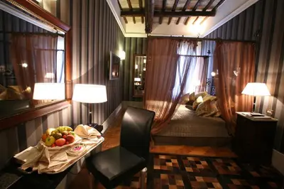 a bedroom with a table with a bowl of fruit on it at The Inn at the Spanish Steps Prestige Collection - MDR Penthouse in Rome