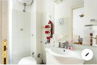 a bathroom with a sink and a toilet and a mirror at 2B Domus Vaticana 
