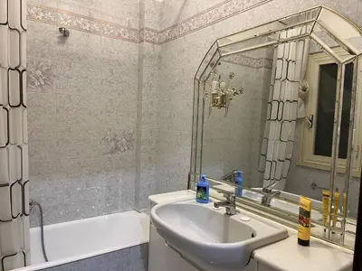 a bathroom with a sink and a mirror and a tub at Domus Amra in Rome