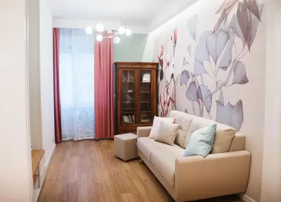 a living room with a couch and a painting on the wall at A Casa di Emy in Rome