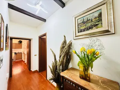 a room with a vase of flowers on a table at Via Veneto Lulus Home in Rome