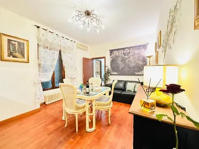 a living room with a table and chairs at Via Veneto Lulus Home in Rome