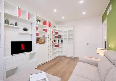 a living room with a couch and a tv at COLOSSEO a 15 minuti - Suite Elegante in Centro in Rome