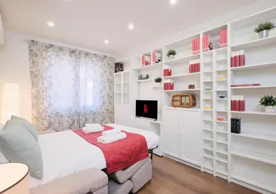 a bedroom with white shelves and a bed at COLOSSEO a 15 minuti - Suite Elegante in Centro in Rome