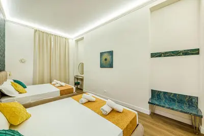 a hotel room with two beds and a mirror at Rome Aparts - 3 bedrooms luxury apartment at St Peter in Rome
