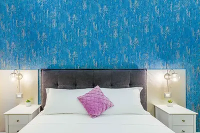 a bed with a purple pillow and a blue wall at Rome Aparts - 3 bedrooms luxury apartment at St Peter in Rome