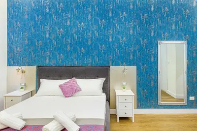 a bedroom with a bed and a blue wall at Rome Aparts - 3 bedrooms luxury apartment at St Peter in Rome