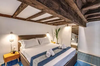 a bedroom with a large bed with towels on it at Monti View Apartment in Rome