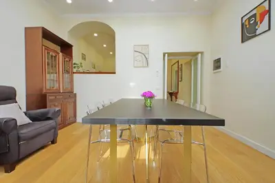 a dining room with a table with a vase of flowers on it at 4BNB - Ripetta Central Apartment in Rome