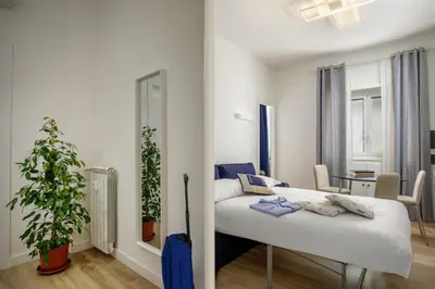 a bedroom with a white bed in a room at Vatican Aurelia House - Vicino alla metro e al Vaticano - Luminoso e moderno in Rome