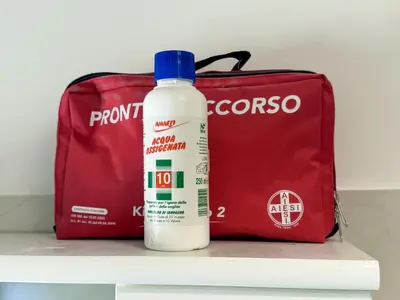 a bottle of bleach next to a red bag at JHHIT Tuscolana Suite 01 with Terrace in Rome
