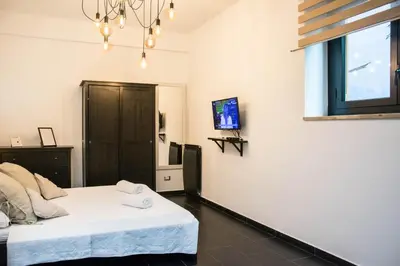 a bedroom with a bed and a tv on the wall at St. Peter Sweets in Rome