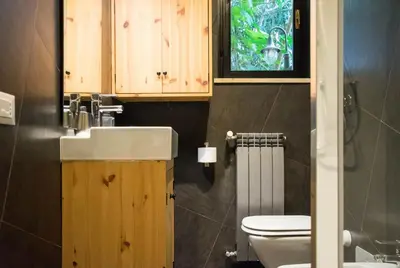 a bathroom with a toilet and a sink and a window at St. Peter Sweets in Rome